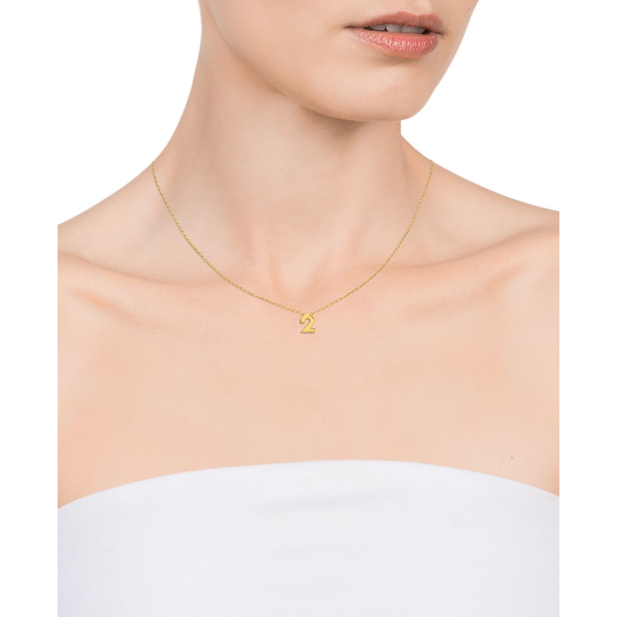 Gold necklace with a number pendant worn by a model on a white background, showcasing elegant jewelry style.