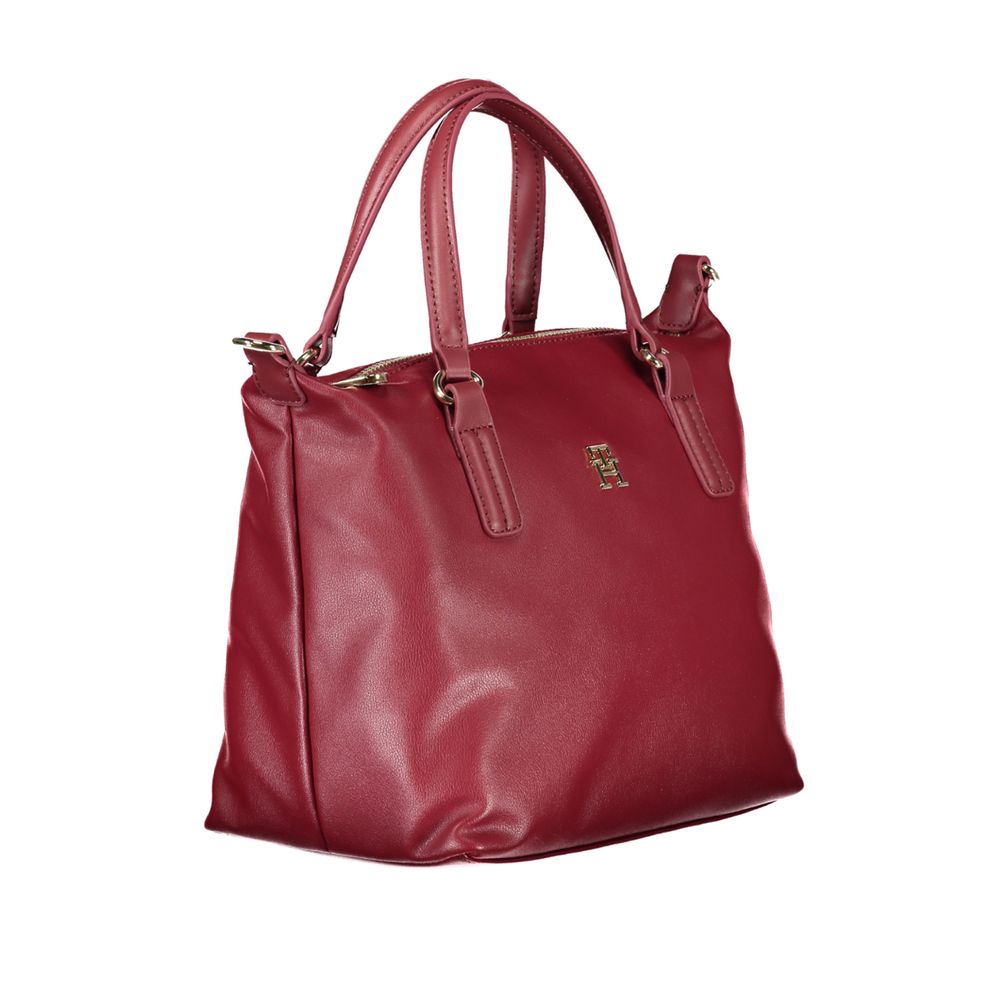 Tommy Hilfiger Red Polyester Handbag with two handles, adjustable shoulder strap, internal pocket, and logo.