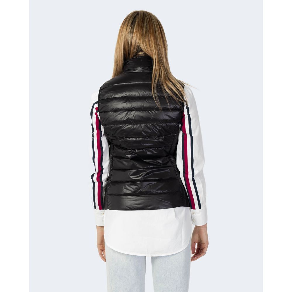 Back view of a woman wearing the Armani Exchange Black Polyester Sleveless Jacket over a white shirt with striped sleeves.