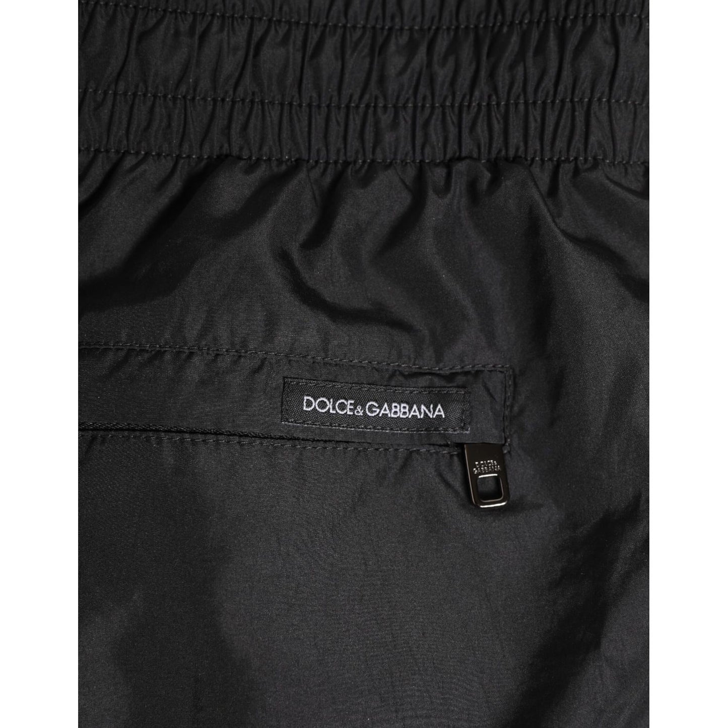 Dolce & Gabbana Black Drawstring Beachwear Men Shorts Swimwear with logo detail and zip pocket.