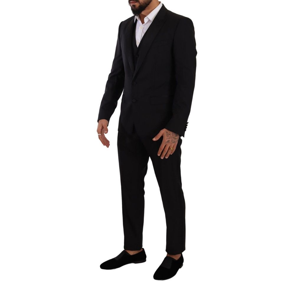 Model wearing Dolce & Gabbana Black Wool Three-Piece Suit with deconstructed blazer and notch lapels