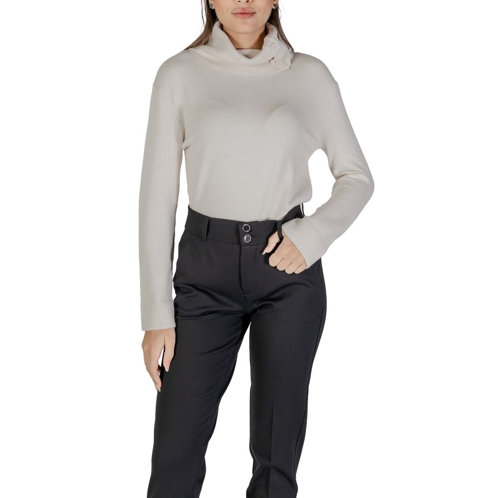Woman wearing Street One Cream Viscose Turtleneck with black pants, showing side button details.