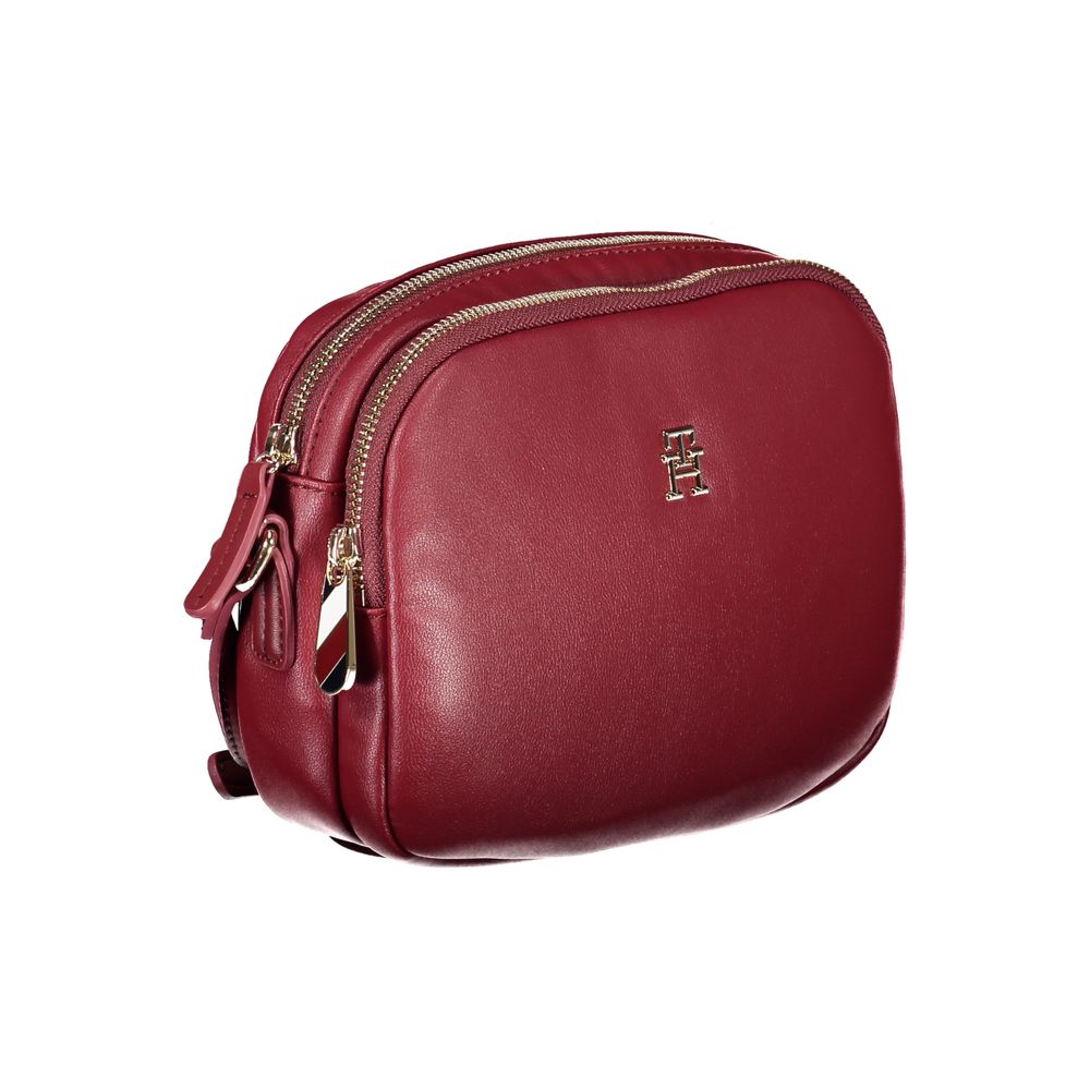 Tommy Hilfiger Red Polyester Handbag with adjustable shoulder strap, two compartments, internal pocket, and zip closure.