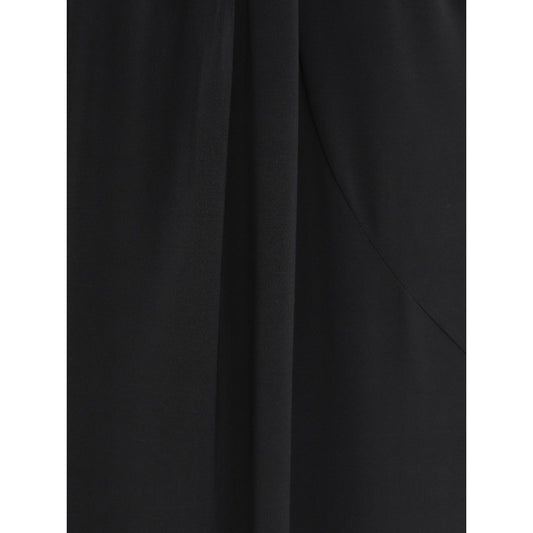 Close-up of black JACQUEMUS Skirts with high waist, front slit, pleat detail, and rear zip fastening.