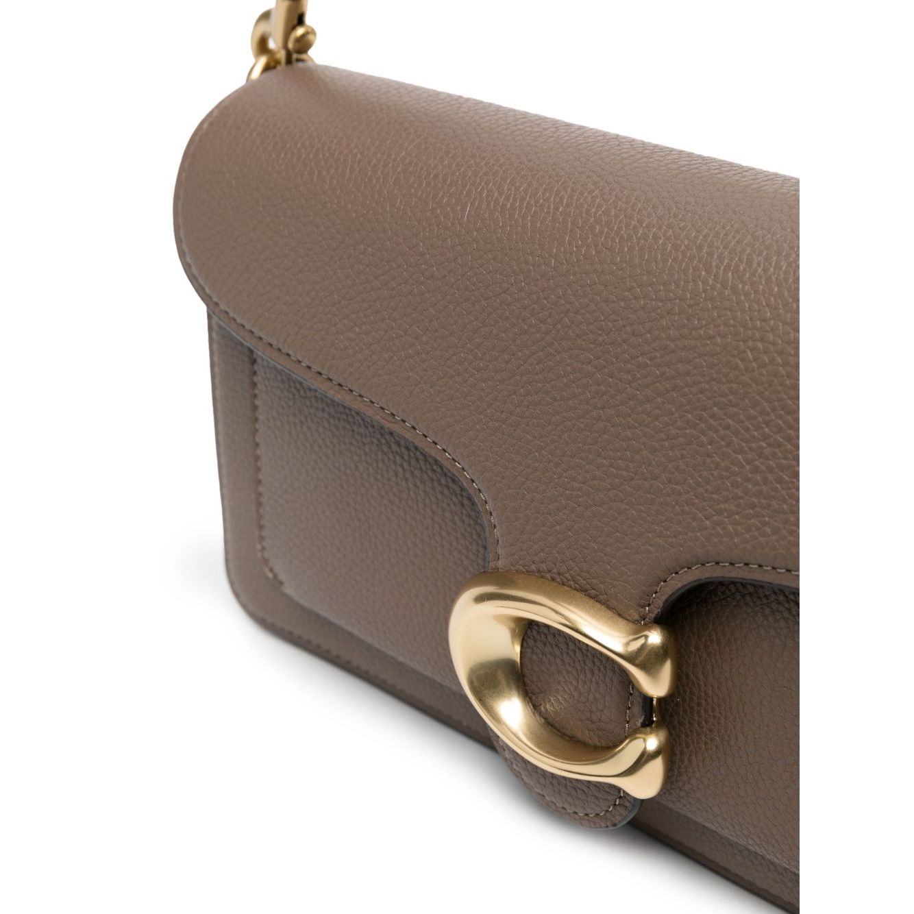 Close-up of Coach Tabby 26 leather shoulder bag with gold-tone hardware and textured leather surface.