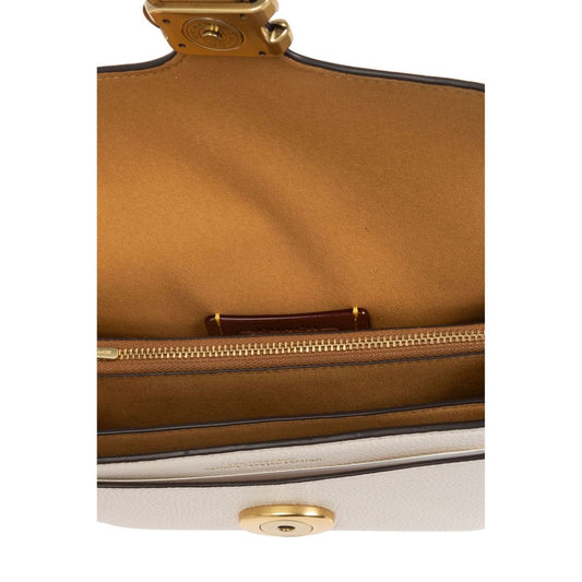 Internal view of Coach Tabby 20 leather crossbody bag showing multifunctional pockets and snap closure