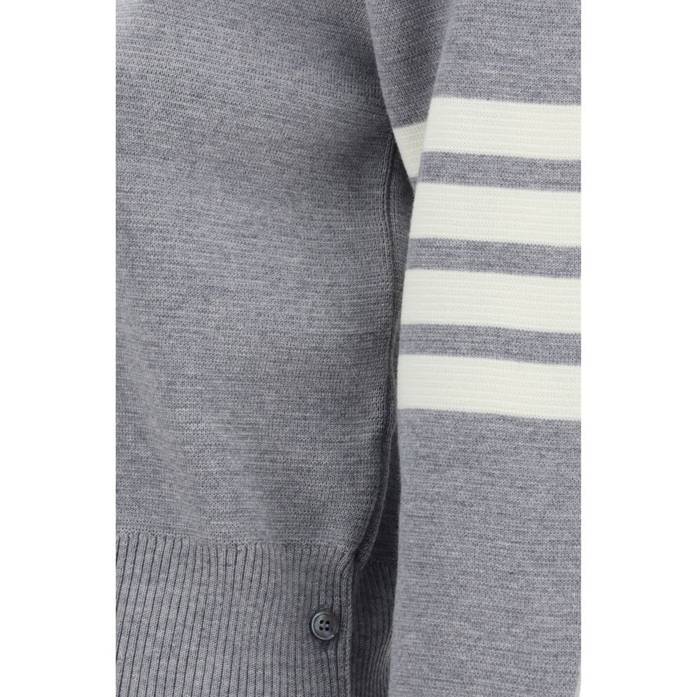 Close-up of Thom Browne Virgin wool Sweater showing iconic horizontal bands and ribbed hem with side buttons.