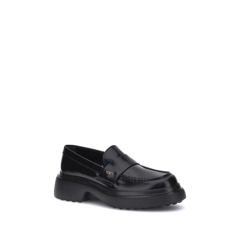 Tod's Black Rubber Platform Loafers with patent leather and rounded toe, featuring side logo plaque and rubber sole for comfort and style.