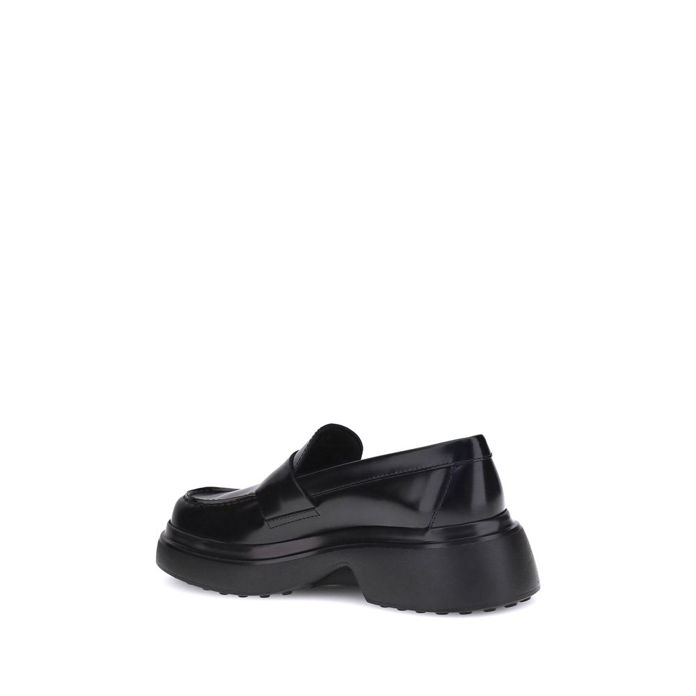Side view of Tod's Black Rubber Platform Loafers with patent leather and distinctive rubber sole.