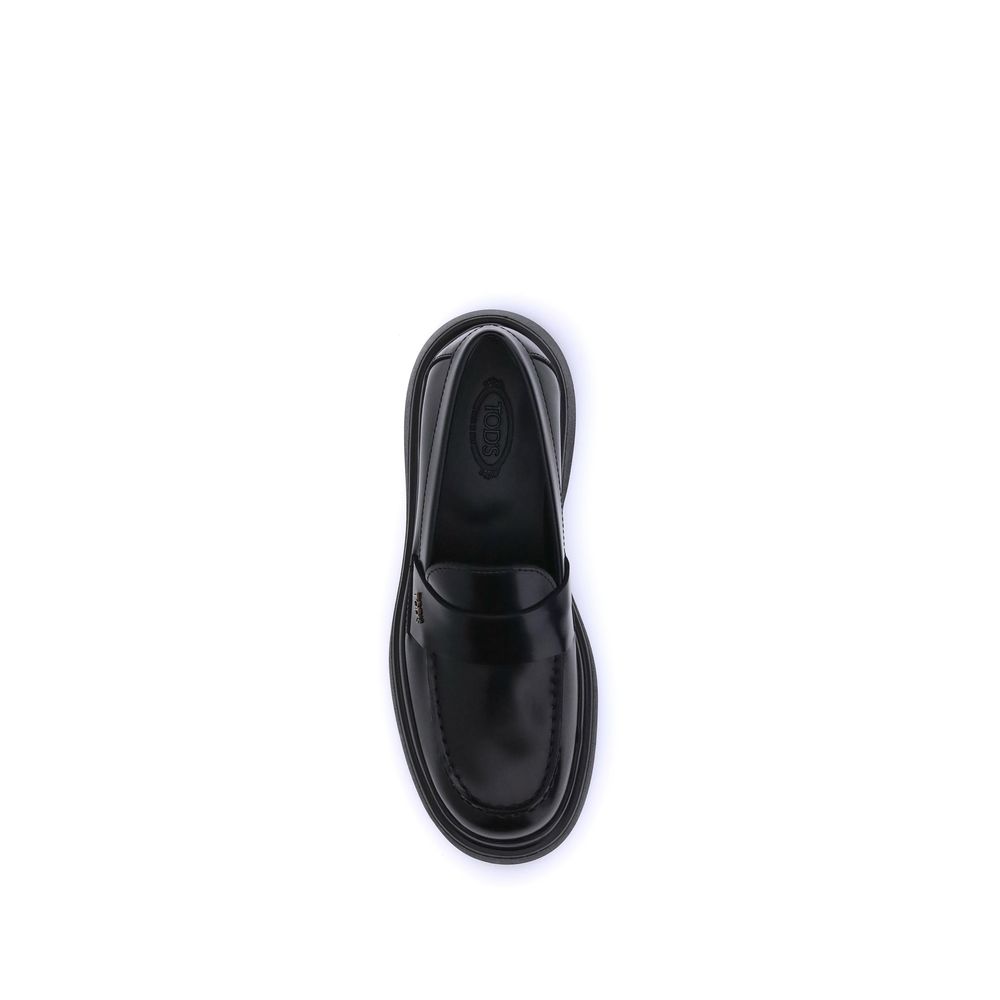 Top view of Tod's Black Rubber Platform Loafers with patent leather and rubber sole showcasing elegant design and comfort.