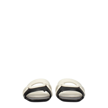 Valentino Garavani Black Leather Slippers with open toe design, low flat heel, and casual style. Secondary color: Ivory. MPN: S0GH7ZUC790.