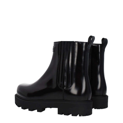 Givenchy Black Leather Ankle Boots with front and back logo, rubber sole, and round toe, featuring mid heels and casual style.