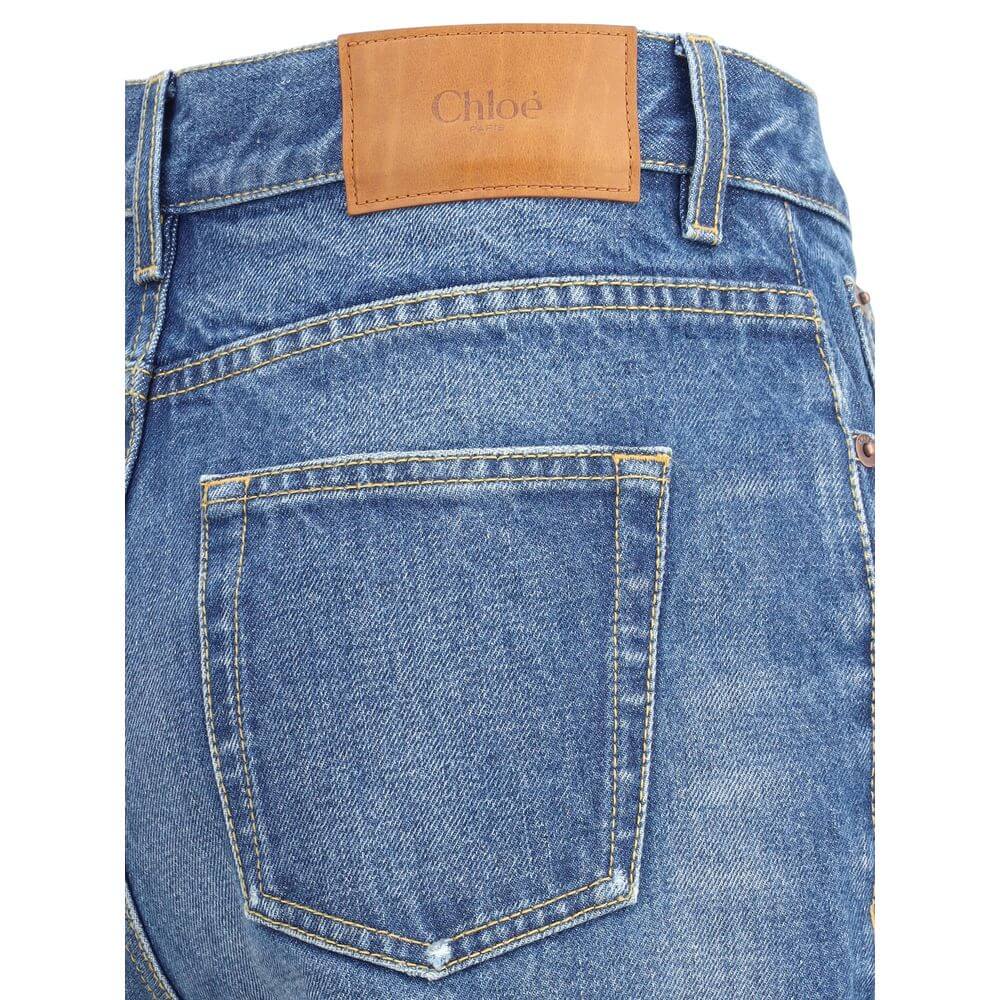 Detailed view of Chloé Blue Cotton Flared Jeans showcasing classic five-pocket design and leather brand patch on waistband