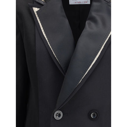 Close-up of Sacai Black Polyester Clothing showcasing double-breasted wool blazer with peaked lapels and button details.