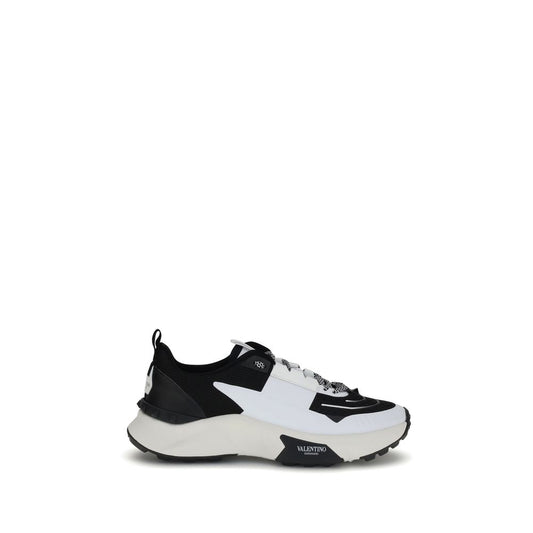Valentino Garavani True Act Sneakers in black and white with studded sole and logo detail.