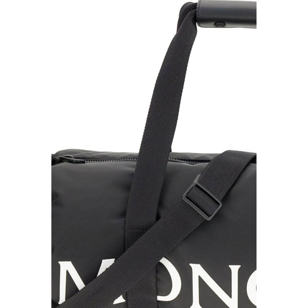 Close-up of Moncler Black Nylon Luggage And Travel bag with adjustable strap and logo.
