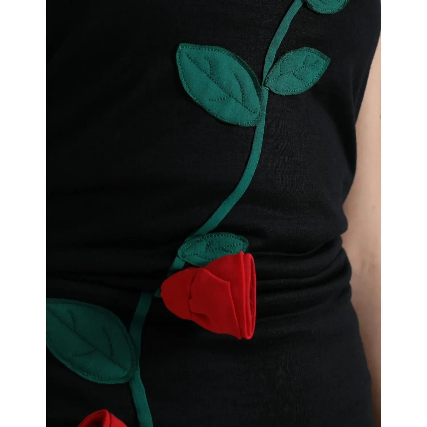 Close-up of Dolce & Gabbana Black Wool Sleeveless Rose Applique Dress showcasing red rose embroidery and elegant design.