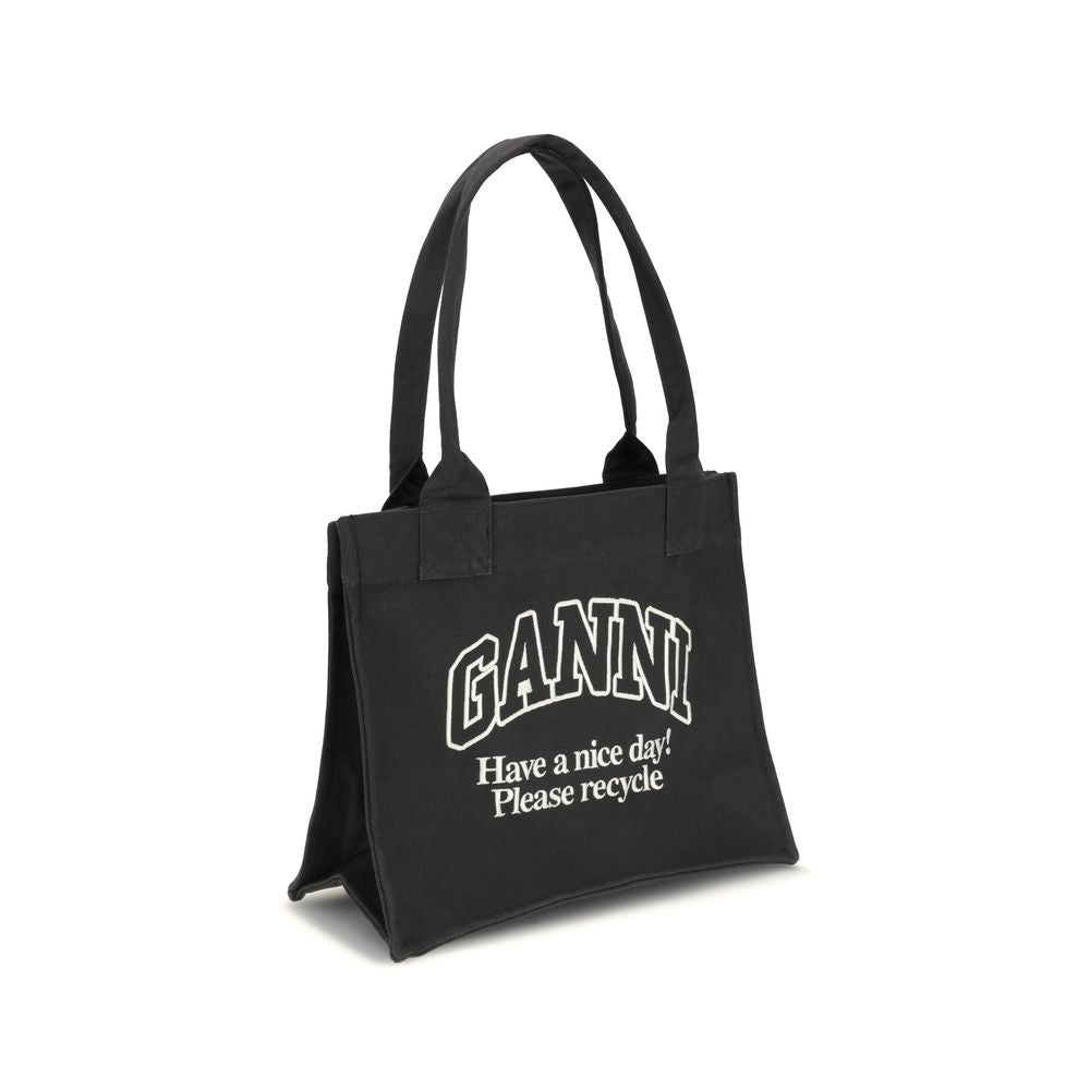 Ganni Black Cotton Shoulder Bag with GANNI logo and 'Have a nice day! Please recycle' message, featuring top handles and roomy interior.