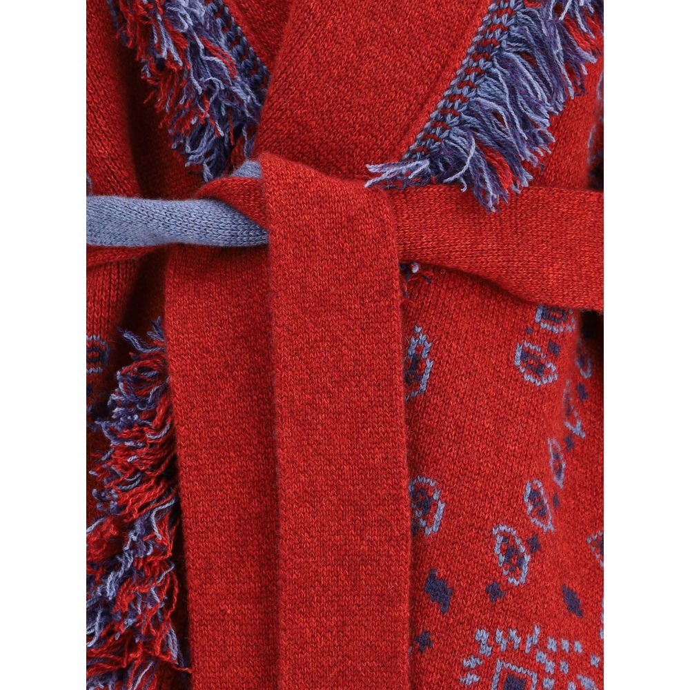 Close-up of the Alanui Bordeaux Cashmere Cardigan showcasing its bandana jacquard pattern with fringed edges and waistband detail.
