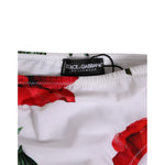 Close-up of Dolce & Gabbana White Floral Swimsuit 2 Piece Top Bottom Swimwear with red floral print and label detail.
