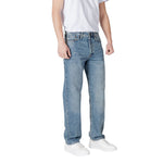 Man wearing Jack Jones Blue Cotton Relaxed Fit Jean standing casually in white sneakers and t-shirt.