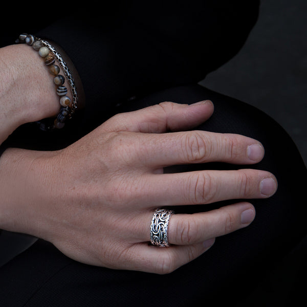 Close-up of a hand wearing ALBERT M. JEWELS JEWELRY Mod. WSOX00396.S-28 silver ring and beaded bracelet.