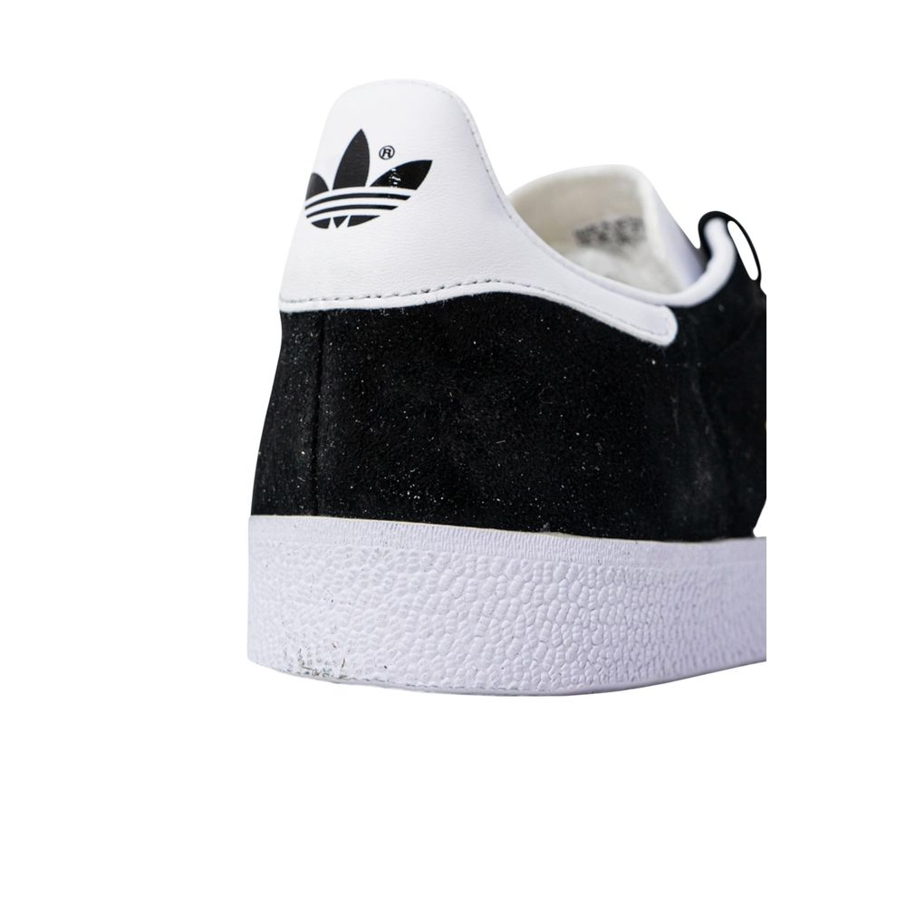 Close-up of Adidas Black Polyethylene Sneaker showing logo and textured rubber sole for excellent grip.