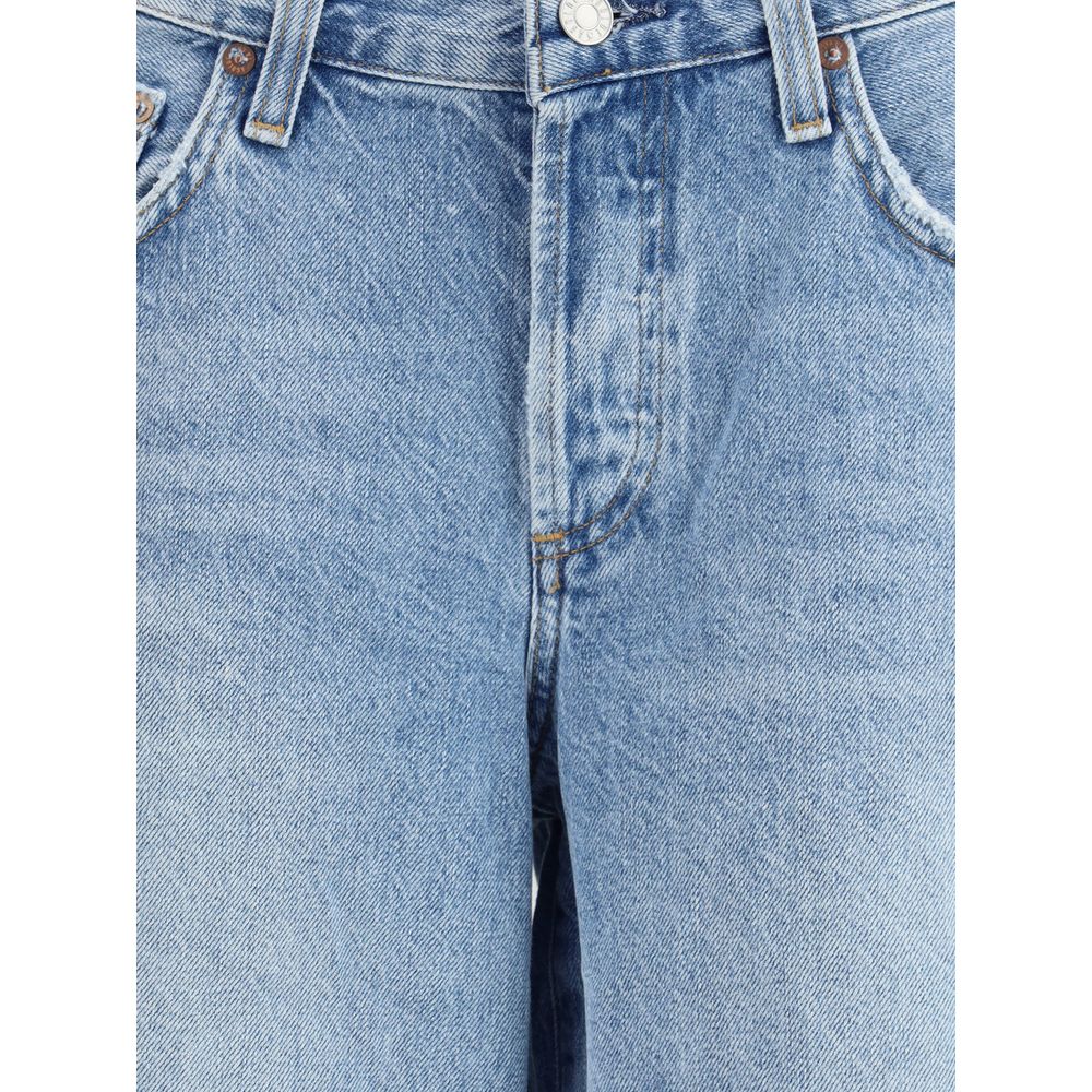 Close-up of Agolde Baggy denim Shorts showcasing button, zipper closure, and belt loops in light blue, 100% cotton, perfect for urban summer style.