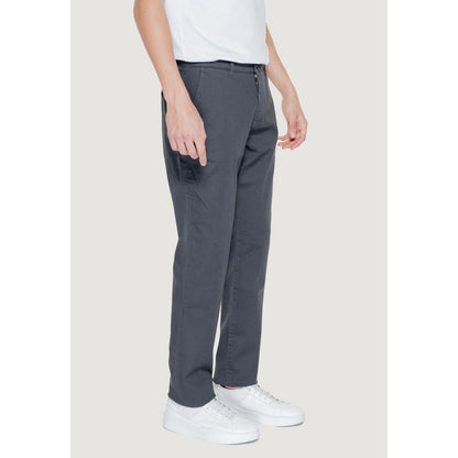 Model wearing Armani Exchange Black Cotton Casual Pants with white shoes, showcasing regular fit and modern style.