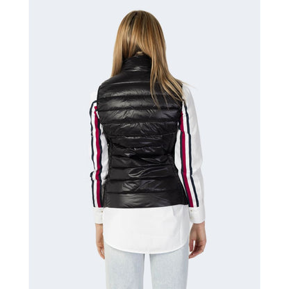 Back view of a woman wearing the Armani Exchange Black Polyester Sleveless Jacket over a white shirt with striped sleeves.