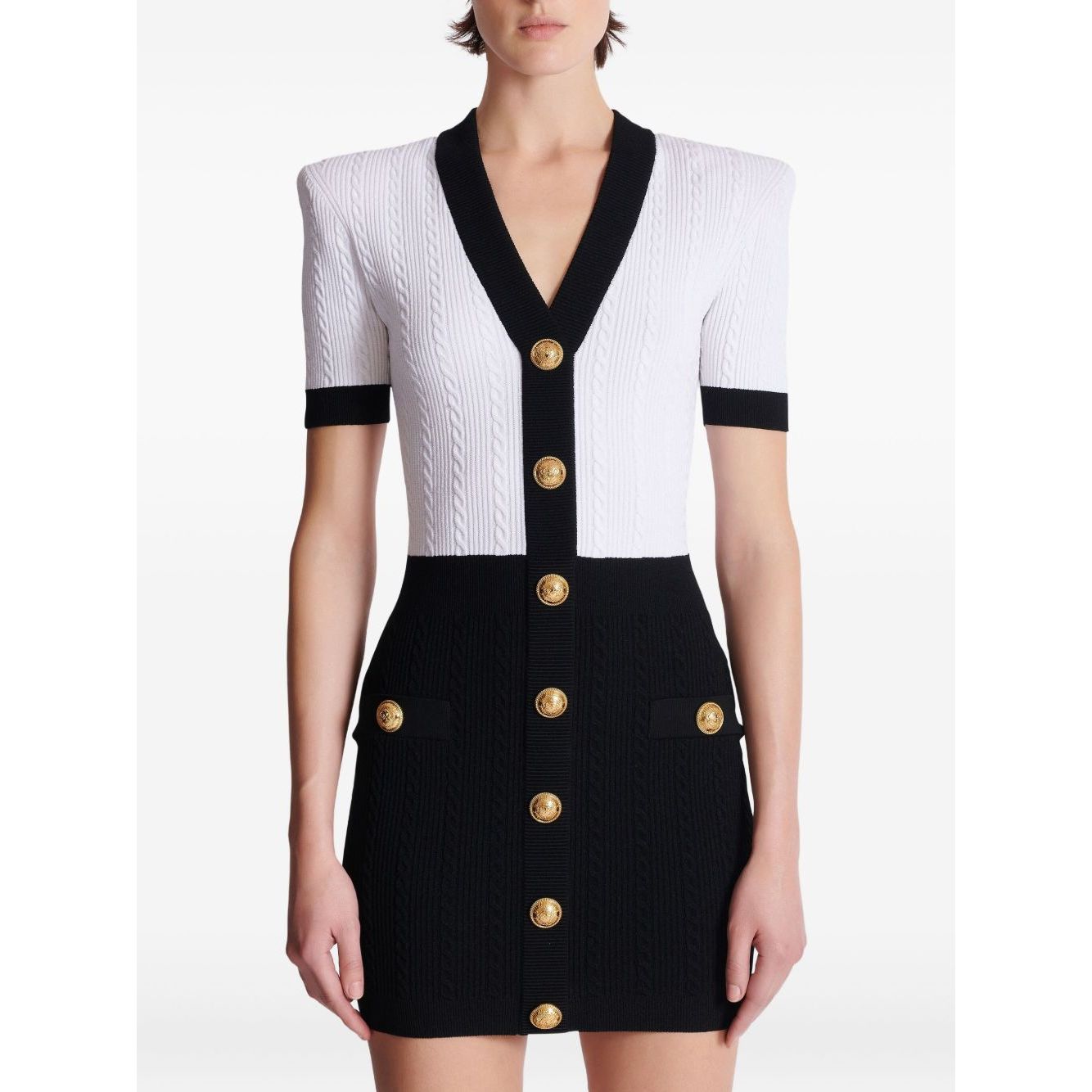 Balmain Two-tone twisted knit bodycon dress with V-neck and button details.