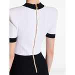 Back view of Balmain Two-tone twisted knit bodycon dress with rear zip fastening and short sleeves.
