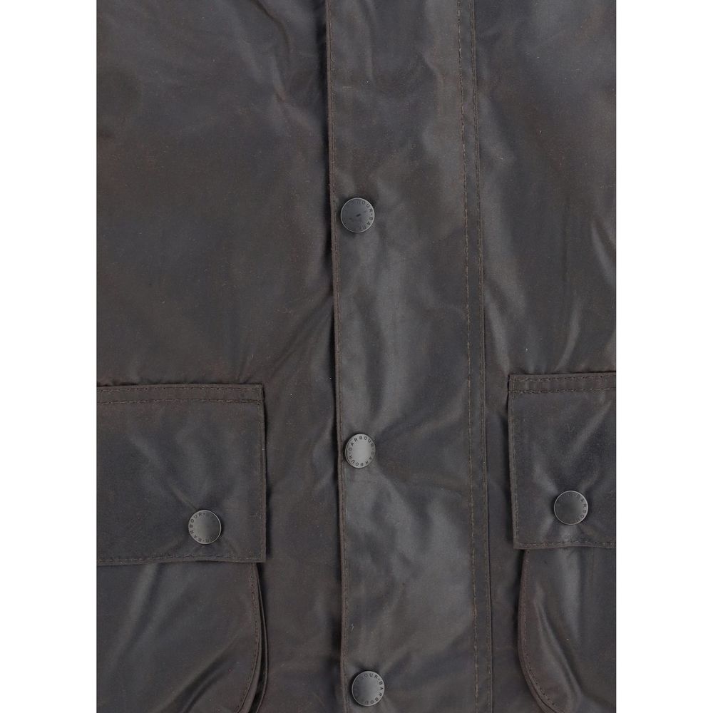 Close-up of Barbour Black Cotton Coat showing waxed fabric, snap buttons, and pockets for style and functionality.
