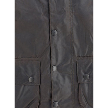 Close-up of Barbour Black Cotton Coat showing waxed fabric, snap buttons, and pockets for style and functionality.