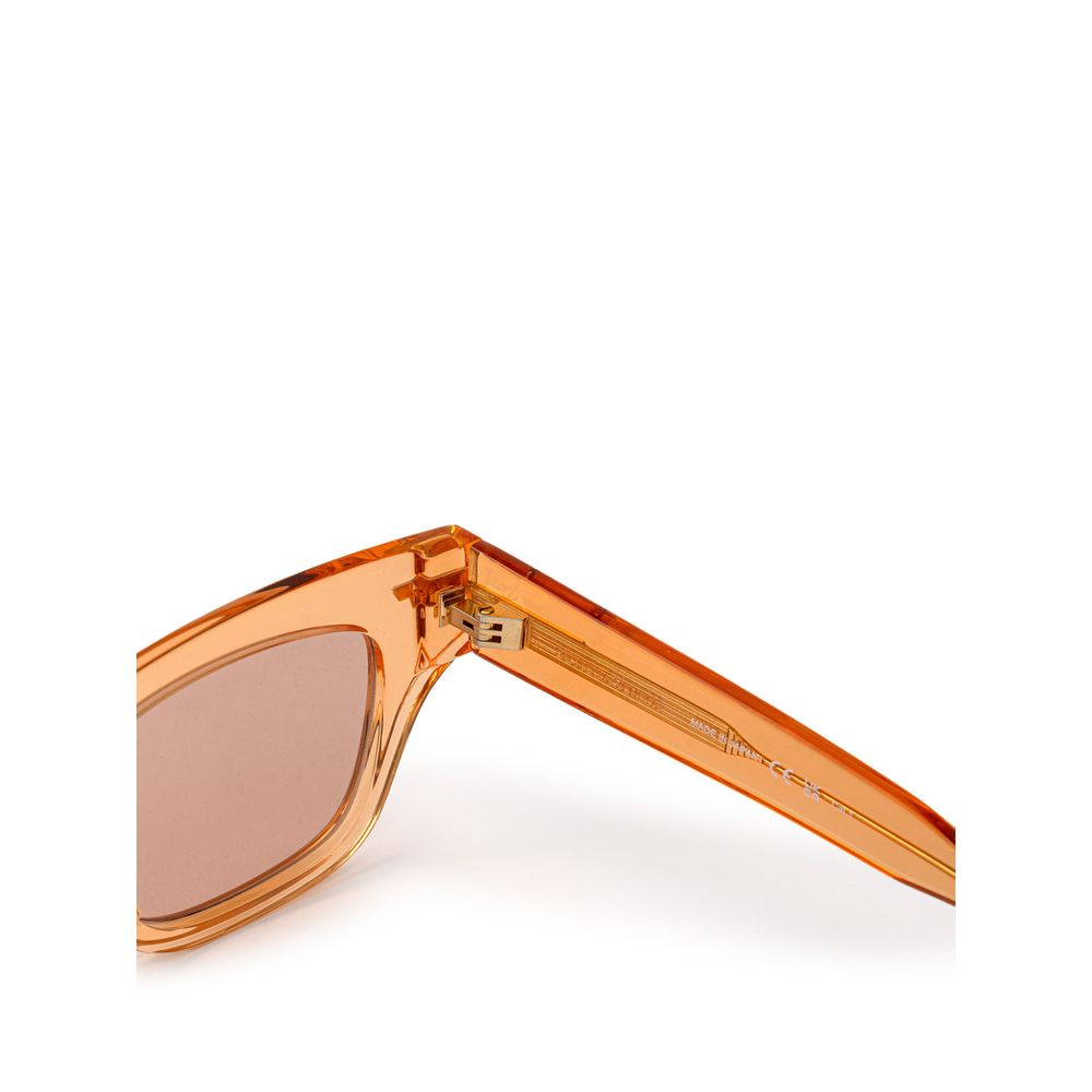 Bottega Veneta Orange Acetate Sunglass with transparent crystal effect frame, orange lens, gold temple details, made from recycled acetate.
