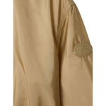 Close-up of Burberry Short nylon parka with check motif and logo badge on sleeve.