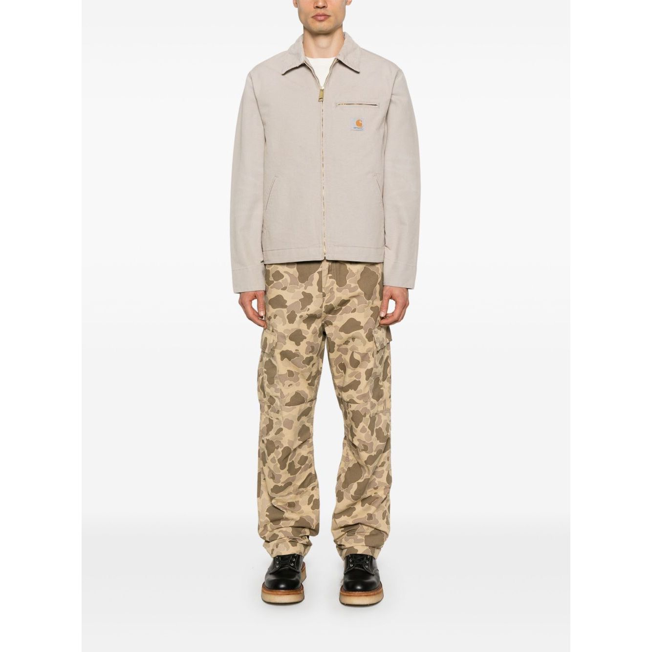 Model wearing CARHARTT WIP MAIN Jackets Beige, featuring a sand beige canvas jacket with zip chest pocket and press-stud cuffs.
