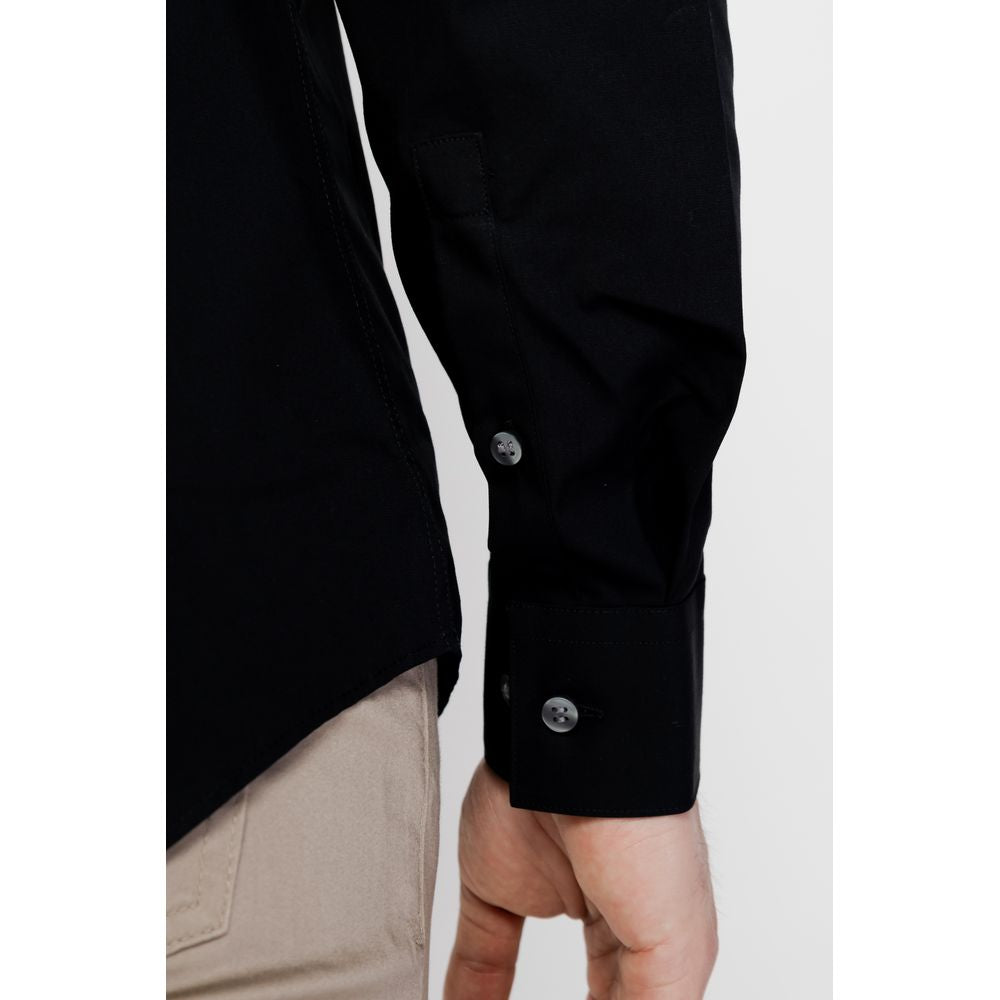 Close-up of Calvin Klein Black Cotton Dress Shirt sleeve with button detail on a person's wrist.