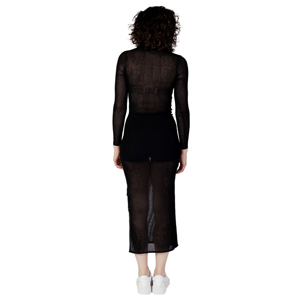 Back view of model wearing Calvin Klein Jeans Black Marabou Long Dress, showcasing sheer fabric and elegant silhouette.