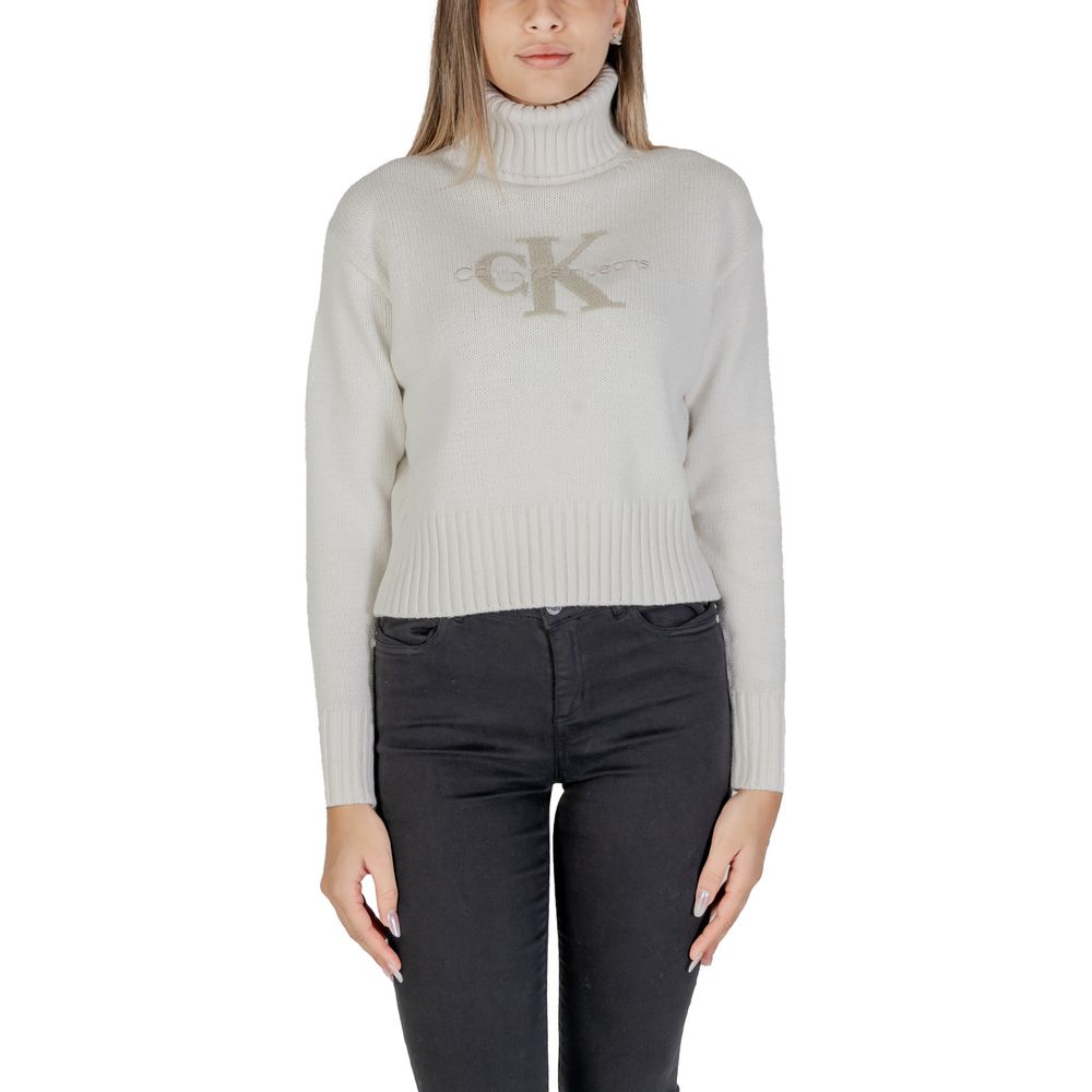 Calvin Klein Jeans Cream Cotton Sweater with CK logo and ribbed turtleneck, women's cropped fit, showcasing modern and refined style.