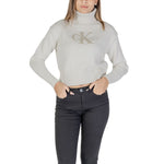 Woman wearing Calvin Klein Jeans Cream Cotton Sweater with embroidered CK logo, ribbed turtleneck, and cropped fit for modern style.