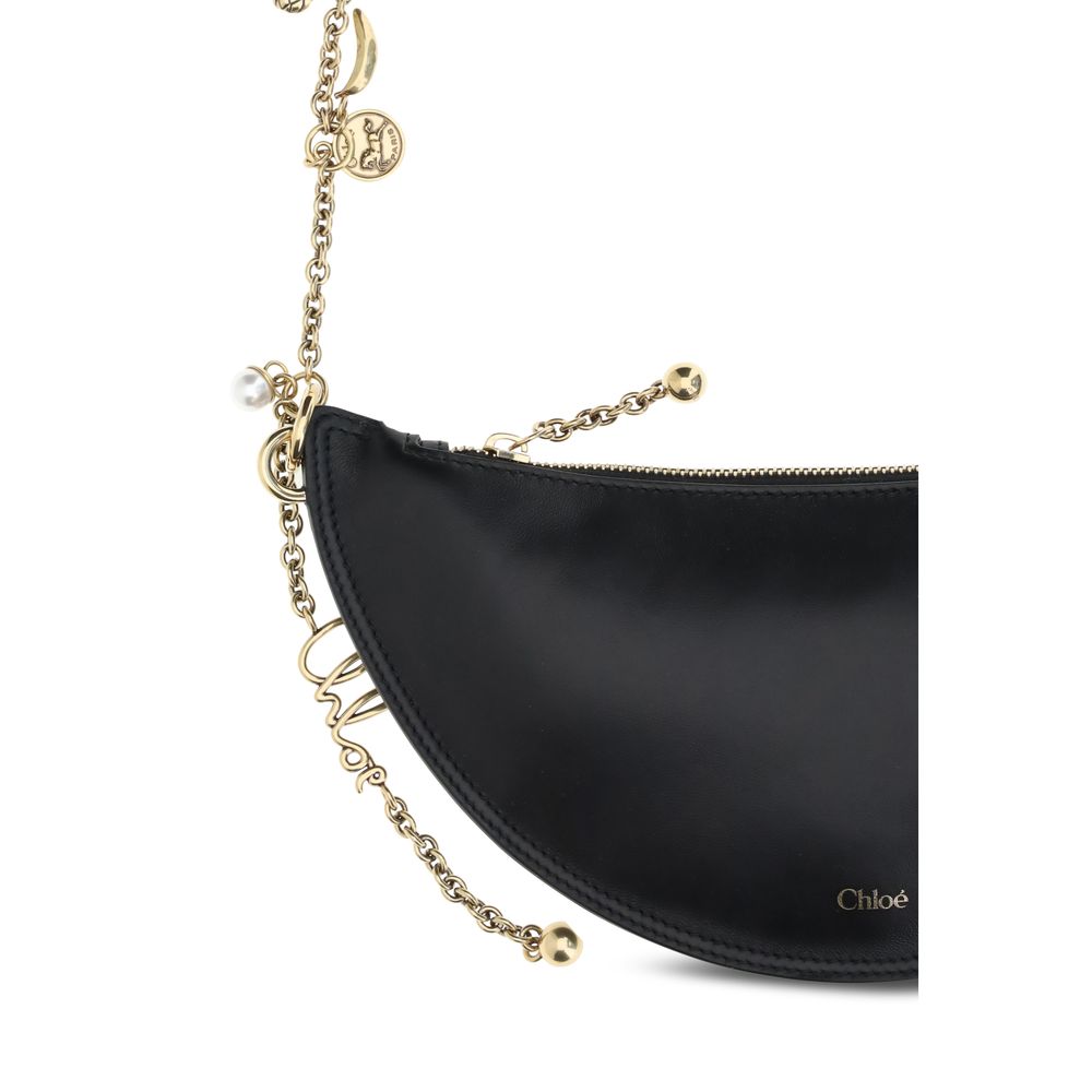 Close-up of Chloé Icons Shoulder Bag in lambskin nappa leather with gold chain and charms.