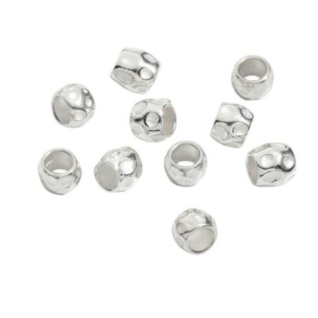 Silver cylindrical charms on white background, suitable for jewelry making.
