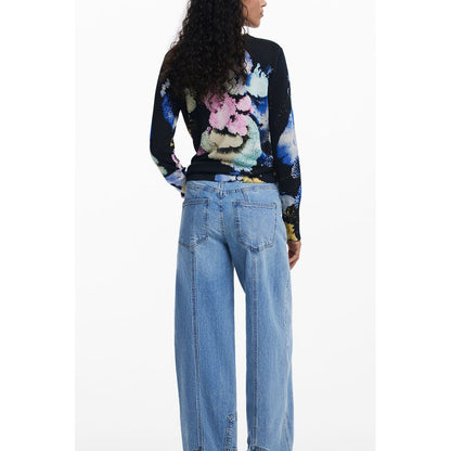 Alt Tag: Woman wearing Desigual Black Linen Women Sweater with floral pattern and blue jeans, showcasing the unique design from the back view.