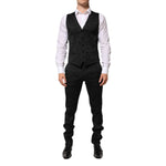 Man wearing Dolce & Gabbana Black 3 Piece Brocade Jacquard Suit MARTINI with waistcoat and trousers, perfect for formal events.