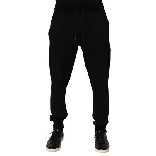 Dolce & Gabbana Black Cotton DG Logo Men Jogger Pants with drawstring closure and repaired holes near pocket area.