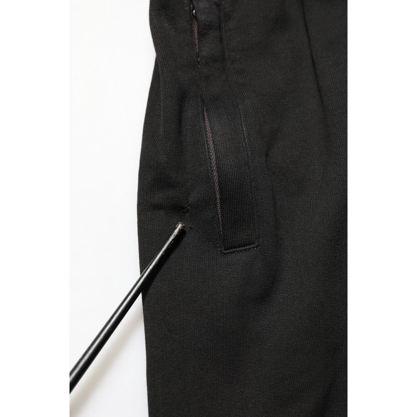Close-up of Dolce & Gabbana Black Cotton DG Logo Men Jogger Pants showing repaired hole near the pocket area.