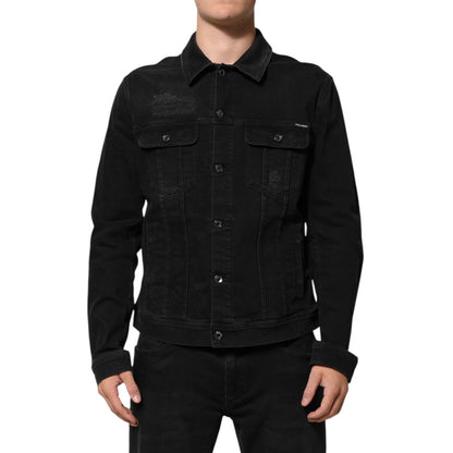 Model wearing Dolce & Gabbana Black Cotton Denim Stretch Button Up Jacket with chest flap pockets and button closure, front view.
