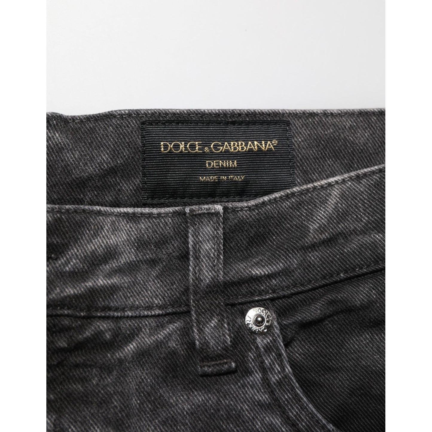 Close-up of Dolce & Gabbana Black Cotton Mid Waist Denim Men Bermuda Short detailing and label.