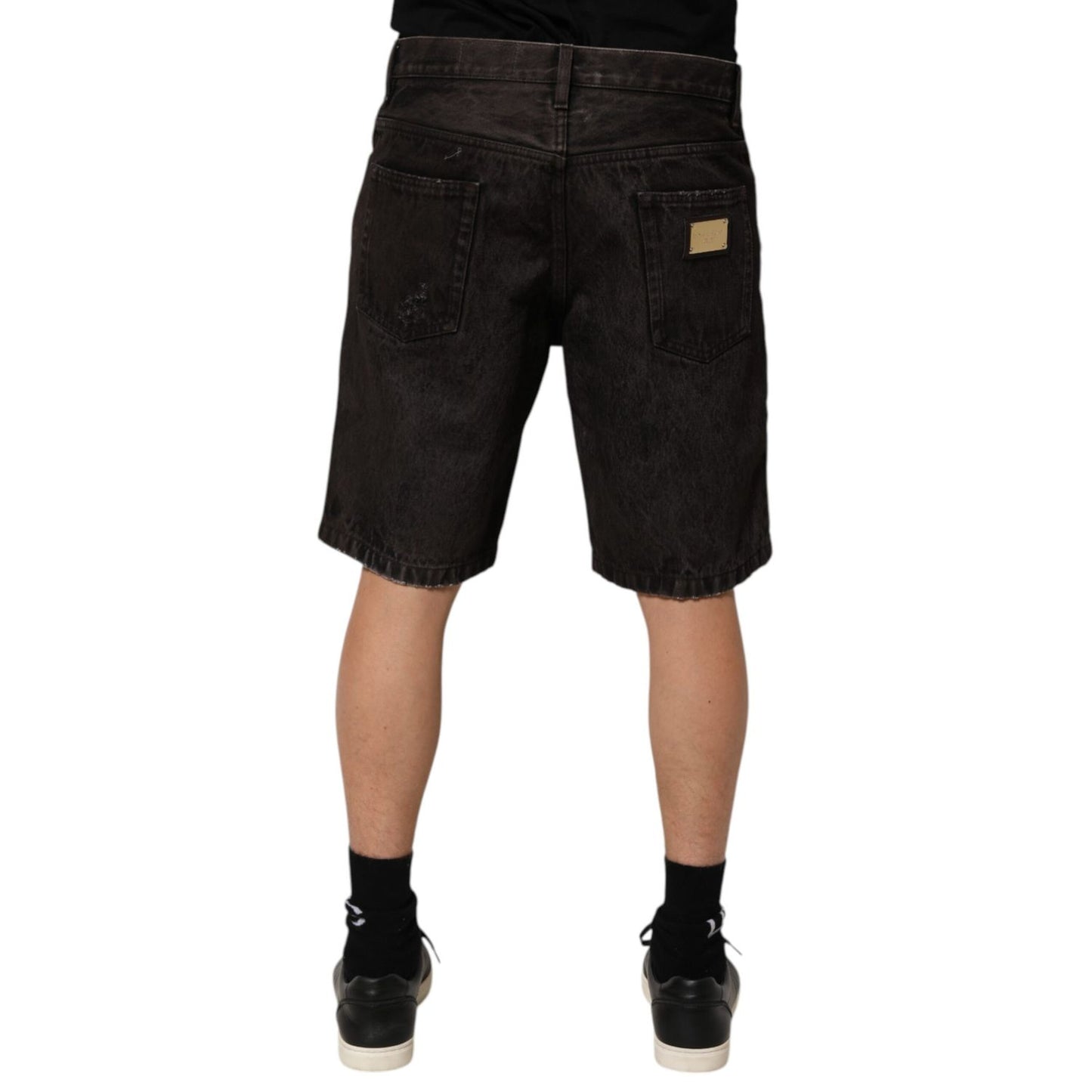 Back view of Dolce & Gabbana Black Cotton Tattered Denim Men Bermuda Short displaying distressed design and regular fit.